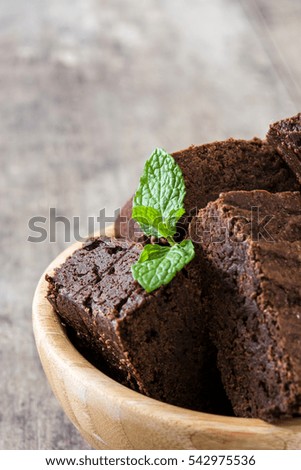 Chocolate brownie pieces on wooden background