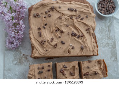 Chocolate Brownie With Salted Caramel Frosting, Cacao Nibs And Fresh Lilac