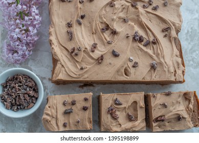 Chocolate Brownie With Salted Caramel Frosting, Cacao Nibs And Fresh Lilac