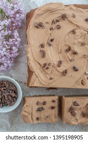 Chocolate Brownie With Salted Caramel Frosting, Cacao Nibs And Fresh Lilac