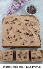 Chocolate Brownie With Salted Caramel Frosting, Cacao Nibs And Fresh Lilac