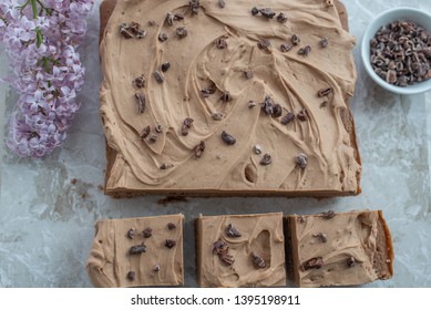 Chocolate Brownie With Salted Caramel Frosting, Cacao Nibs And Fresh Lilac