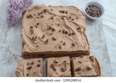 Chocolate Brownie With Salted Caramel Frosting, Cacao Nibs And Fresh Lilac