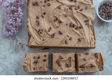 Chocolate Brownie With Salted Caramel Frosting, Cacao Nibs And Fresh Lilac