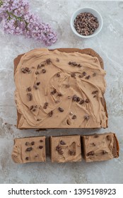 Chocolate Brownie With Salted Caramel Frosting, Cacao Nibs And Fresh Lilac