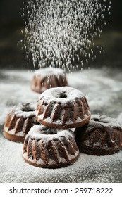 Chocolate Bundt Cakes With Icing Sugar On Black Background