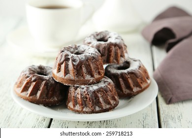 Chocolate Bundt Cakes On Plate On White Wooden Background