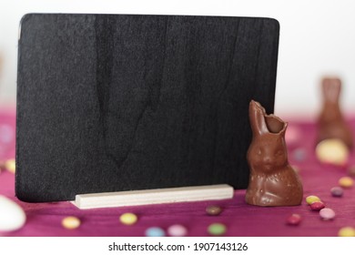 Chocolate Bunny Missing A Bite And Blackboard With Copy Space