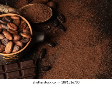 Chocolate And Cacao Concept. Cocoa Powder In Bowl Near Cocoa Beans And Broken Chocolate On Black Background