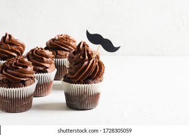 Chocolate Cacao Cupcakes With Moustache,  Fathers Day Concept, Copy Space On White Background, Banner