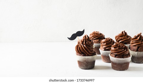 Chocolate Cacao Cupcakes With Moustache,  Fathers Day Concept, Copy Space On White Background, Banner