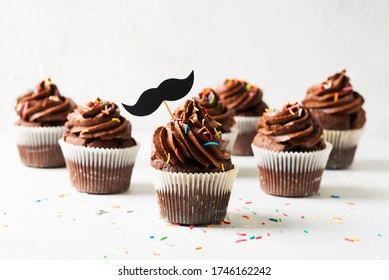 Chocolate Cacao Cupcakes With Moustache And Sprinkles Decor, Fathers Day Concept, Copy Space On White Background