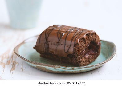 Chocolate cake with blackcurrant in ceramic plate on white wooden background.close up - Shutterstock ID 2040217772