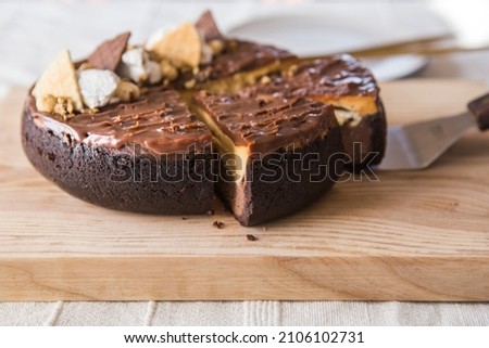 chocolate cake with caramel on light background. snickers cake.