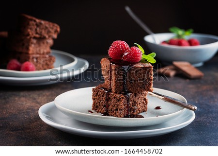 Chocolate cake with caramel, raspberry and mint, selective focus image