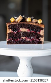 Chocolate cake with cherry conf in section on a white plate. Food photo banner for advertising a confectionery bakery
