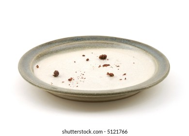 Chocolate Cake Crumbs Sit On An Empty Plate.