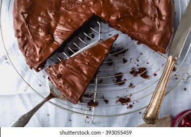 Chocolate cake cut into several pieces with decoration - Shutterstock ID 393055459