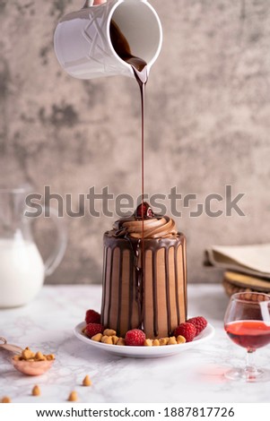 Chocolate Cake Dessert with chocolate syrup pour kitchen setting 