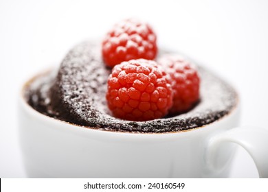 Chocolate Cake In A Mug On White Background With Spoon And Napkin