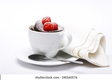 Chocolate Cake In A Mug On White Background With Spoon And Napkin