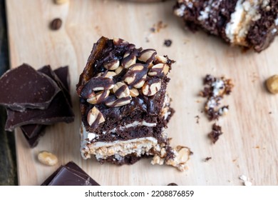 chocolate cake with nut filling and peanuts, dessert of chocolate cake with peanuts on the board - Shutterstock ID 2208876859