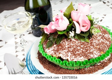 Chocolate Cake With Pink Rose On The Wood Table With Champagne