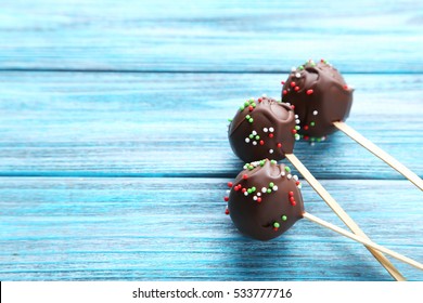 Chocolate Cake Pops On Blue Wooden Table