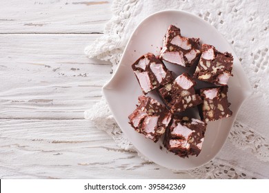 Chocolate Cake Rocky Road With Marshmallow And Nuts Close-up On A Plate On The Table. Horizontal View From Above
