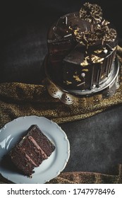 Chocolate cake with a slice of it on a side - Shutterstock ID 1747978496