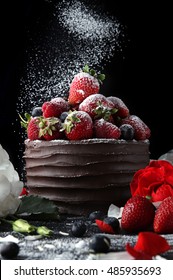 Chocolate Cake With Strawberry And Raspberry Decorating With Flowers On Black Background