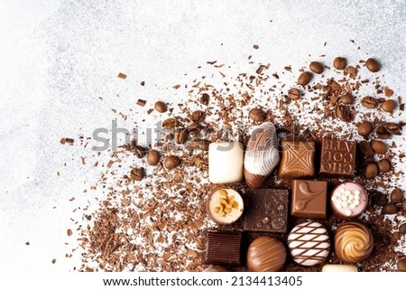 Chocolate candies and chocolate pieces pile for background, close up