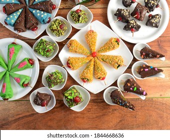 chocolate candies with various fillings, sweet food on wooden background.