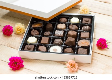 Chocolate Candy In The Box On Wood Background.