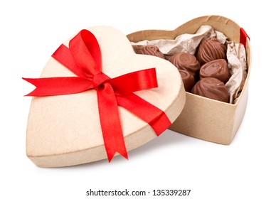 Chocolate candy in a box with a red bow