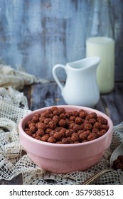 Chocolate Cereal Balls In Bowl And Milk. Selective Focus