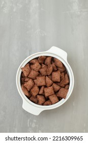 Chocolate Cereals In Small White Bowl On Gray Ceramic