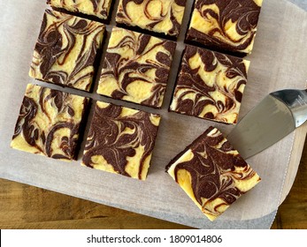 Chocolate cheese brownies squares on a board