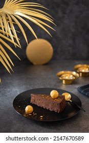 Chocolate Cheesecake Decorated With Golden Truffle On A Dark Table. Piece Of Chocolate Cake On A Black Plate. Close Up, Square. Confectionery, Bakery Menu. No Bake Chocolate Mousse Dessert Recipe