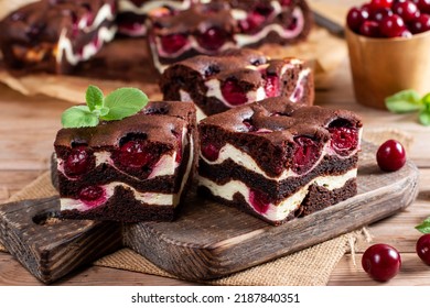 Chocolate cheesecake layered with brownie and dark cherrie. Chocolate cherrie cake. Pieces of chocolate cake. Traditional american cuisine. Still life of food. - Shutterstock ID 2187840351
