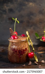Chocolate And Cherry Chia Pudding In A Dark Background