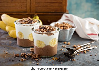 Chocolate Chia Pudding Parfait With Banana, Granola And Yogurt.