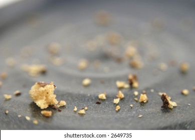 Chocolate Chip Cookie Crumbs On A Pottery Plate.