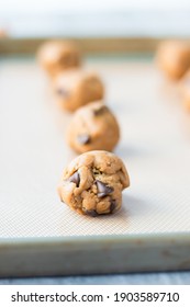 Chocolate Chip Cookie Dough Balls On A Baking Sheet