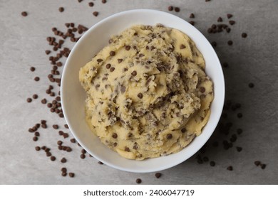 Chocolate chip cookie dough in bowl on gray table, top view - Powered by Shutterstock