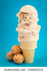 Chocolate Chip Cookie Dough Ice Cream Cone Isolated On A Blue Background