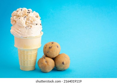 Chocolate Chip Cookie Dough Ice Cream Cone Isolated On A Blue Background