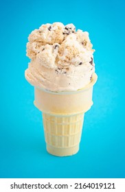 Chocolate Chip Cookie Dough Ice Cream Cone Isolated On A Blue Background