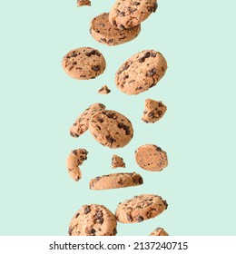 Chocolate chip cookie floating on a green background. Aesthetic sweet food concept. Flying chocolate biscuits	