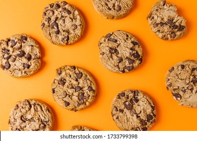 Chocolate Chip Cookie Pattern On Orange Background, Top View